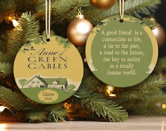 May include: Two round ceramic ornaments featuring Anne of Green Gables imagery. One side displays the house illustration with the text Anne of Green Gables, Claire, and 2026. The other side features the quote A good friend is a connection to life.