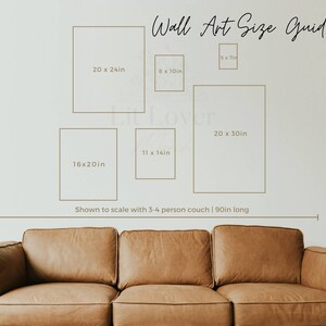 May include: A guide to wall art sizes, showing different frame sizes in inches, with a couch in the bottom of the image. The text reads "Wall Art Size Guide" and "Shown to scale with 3-4 person couch | 90in long".