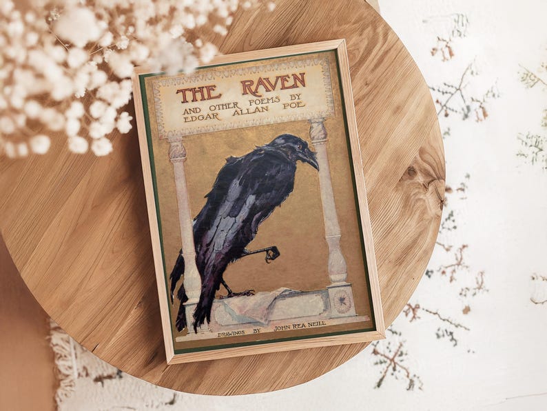 a framed illustration of a black raven perched on a stone column, with the title "The Raven" prominently displayed.