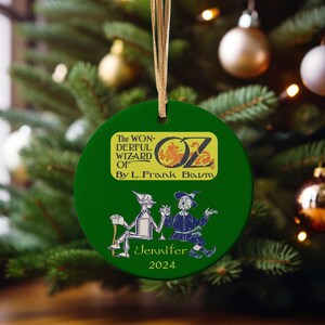 a green ornament hanging from a christmas tree