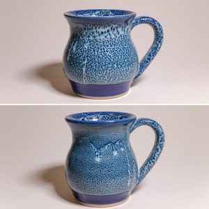 May include: A handmade ceramic mug with a textured, speckled blue glaze. The mug features a dark blue base and rim, with a curved handle. The interior and handle have a lighter blue glaze. This unique mug is perfect for coffee or tea.