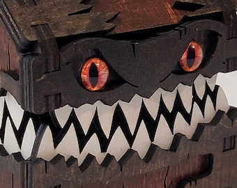 May include: A wooden treasure chest with a menacing face. The chest is painted brown and has a set of sharp teeth. The eyes are red and glow in the dark.