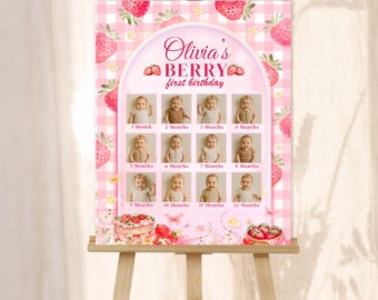 Peut inclure: Un tableau de jalons mensuels rose et blanc sur un chevalet en bois. Le tableau présente un thème de fraises avec le texte "Olivia's Berry first birthday". Il comprend des espaces pour des photos mensuelles de 1 à 12 mois. Le bas du tableau indique "Editable 1st Year Monthly Milestone Board Template."