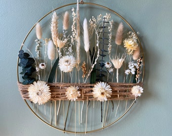 Boho hoop with earthy beige flowers and eucalyptus leaves. Metal gold ring with jute cord and blooms in farmhouse style.