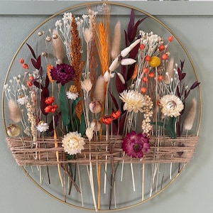 Autumn decoration with dried flowers. Gold floral hoop with jute twine. Wall decor for boho style house