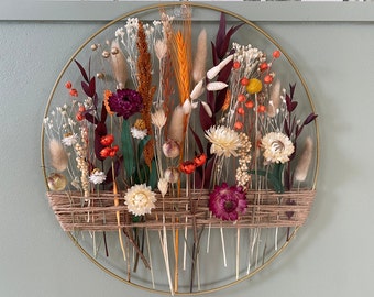 Autumn decoration with dried flowers. Gold floral hoop with jute twine. Wall decor for boho style house