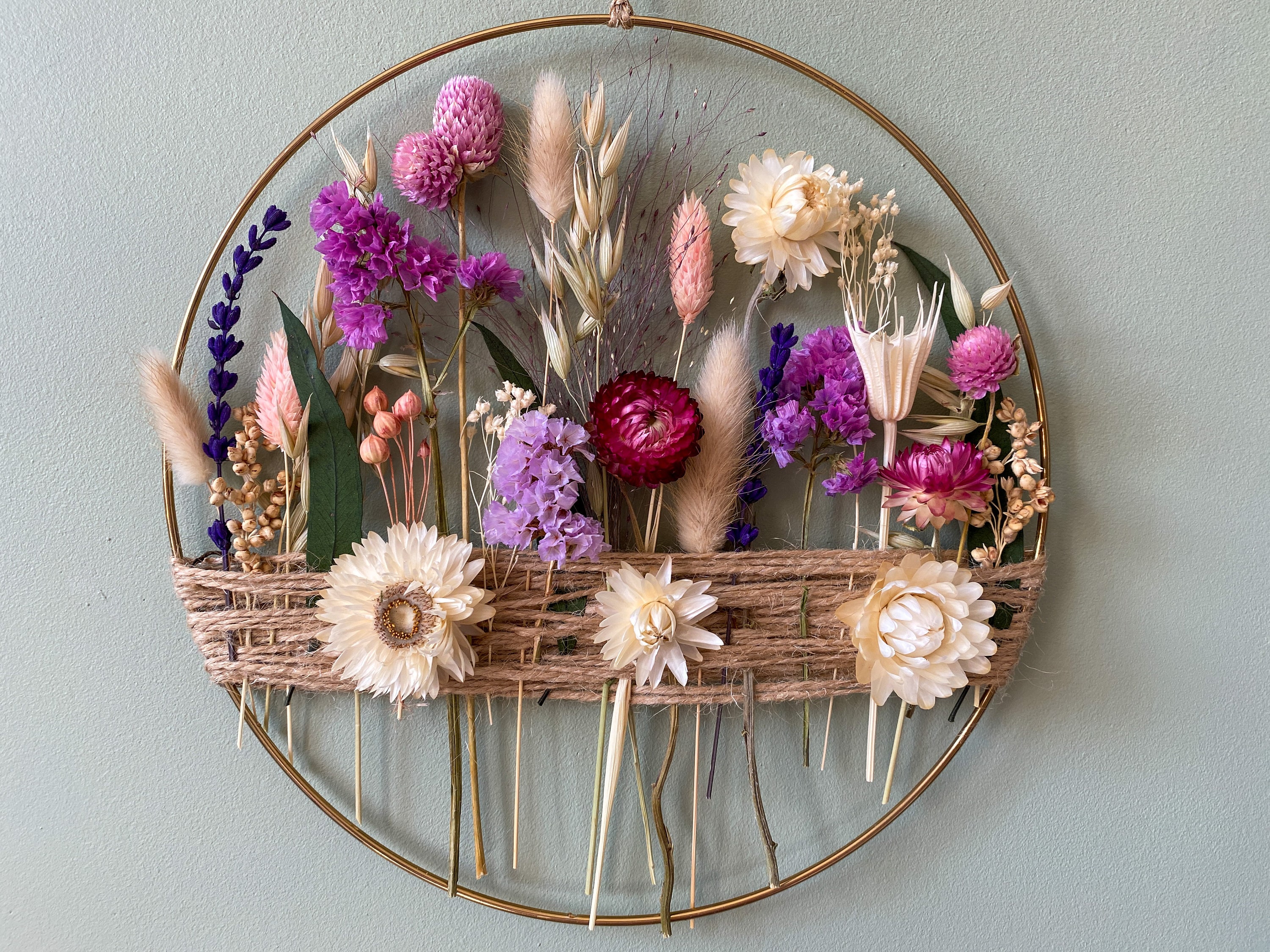 Gold hoop with preserved flowers and jute twine. Minimalist wall hanging art. Home decor in summer and autumn vibes