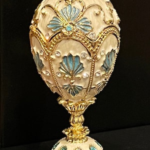 SALE! Faberge type egg which opens for jewelry is a big 5 inch tall egg Austrian crystals. Cream and light blue pearl on top!