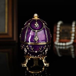 Faberge type egg in a purple unique color. Swarovski crystals tastefully done. It opens to be a trinket box out of stock until May 1