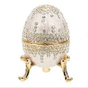 CeilFaberge type egg in a silver large and small Swarovski crystals.It has a waterfall effect since the crystal are different sizes3.5”tall.