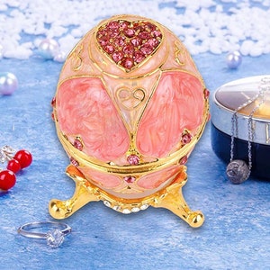 Valentine Faberge type pink egg. It has Swarovski crystals heart on it. Great for any occasion 2,75” on stand opens to hold jewelry.