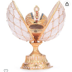 Fabulous Faberge style egg. It opens to a beautiful crown all Swarovski crystals. It is a lace pattern on outside of egg crystals 5” Gift!