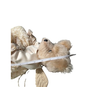 May include: A white ceramic mug with a black handle and the text "But First, Coffee" in a black, handwritten-style font. The mug is on a white surface.