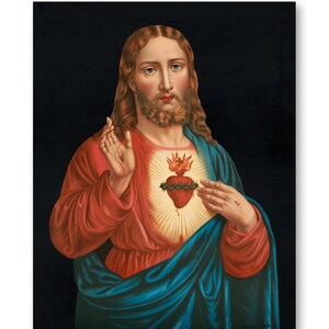 May include: A painting of Jesus Christ with a red heart on his chest. The heart is surrounded by a crown of thorns and is on fire. The painting is on a black background.