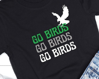 May include: Black t-shirt with a white silhouette of a bird and the text "Go Birds" repeated three times in green, gray, and white.