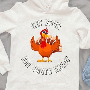 May include: White hooded sweatshirt with a Thanksgiving turkey graphic and the text "Get your fat pants ready".