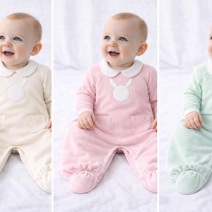 Peut inclure: Trois barboteuses pour bébés, crème, rose et vert menthe. Chacune a un col Claudine blanc, un appliqué lapin et des pieds. Les bébés sourient. Ils sont assis sur une surface blanche.