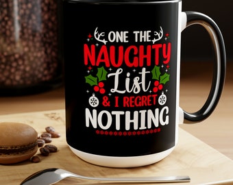 May include: Black and white coffee mug with a red and green Christmas design. The mug says "One the Naughty List & I Regret Nothing".