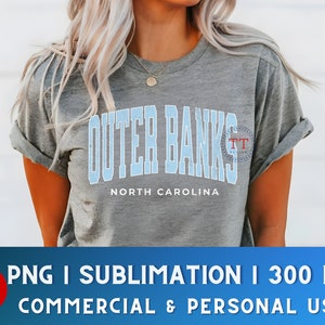May include: A gray t-shirt with a blue and white graphic that says "Outer Banks" and "North Carolina".