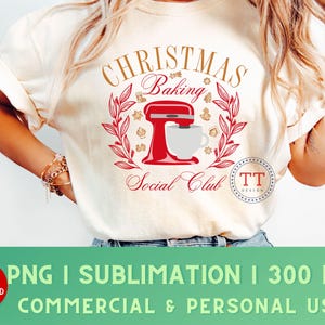 May include: A white t-shirt with a gold design that says "Christmas Baking Social Club" with a red and white stand mixer and a red and white mug. The design also includes red and white holly leaves and berries.