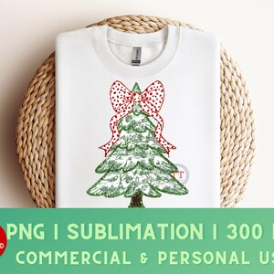 May include: A white sweatshirt with a green Christmas tree design. The tree is decorated with a red and white polka dot bow. The text "PNG | SUBLIMATION | 300 DPI COMMERCIAL & PERSONAL USE" is at the bottom of the image.