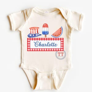 May include: A white baby bodysuit with a red, white, and blue Fourth of July theme. The bodysuit features a watermelon slice, an ice cream pop, and a top hat with stars and stripes. The text "Charlotte" is printed on a red and white checkered background.