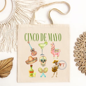 Pu&ograve; includere: Una borsa tote bianca con il testo "Cinco de Mayo" stampato in verde. La borsa presenta una variet&agrave; di illustrazioni tra cui una chitarra, una margarita, un lama, un sombrero, uno scheletro, maracas e uno scheletro che suona la chitarra.