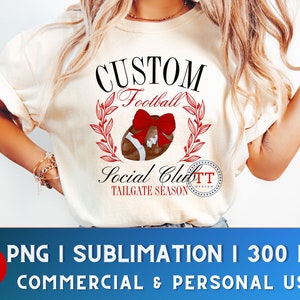 May include: A white t-shirt with a design featuring a football with a red bow, surrounded by green leaves. The text "CUSTOM Football Social Club TAILGATE SEASON" is printed on the shirt.