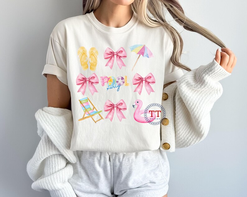 May include: A white t-shirt with a pink and yellow summer themed design. The design includes flip flops, bows, a beach chair, a flamingo float, and the words "Pool Party".