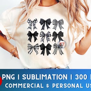 May include: A white t-shirt with a design of nine black and white bows. The bows are arranged in three rows of three. The bows are all different shapes and sizes. The t-shirt is a sublimation design, which means the design is printed directly onto the fabric.