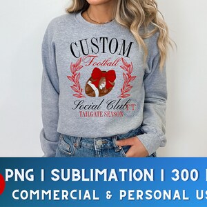 May include: A gray sweatshirt with a design that says "CUSTOM Football Social Club TAILGATE SEASON". The design features a football with a red bow on top.