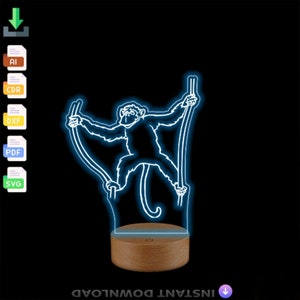 May include: A 3D printed night light with a white outline of a monkey on stilts. The light is on a wooden base and has a blue glow.
