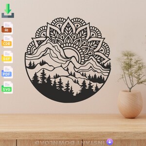 May include: Black and white mandala design with a mountain and forest scene inside. The design is circular and has a detailed pattern.