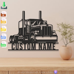 May include: Black metal wall art depicting a semi-truck with the words "CUSTOM NAME" beneath. The truck is a detailed silhouette with two exhaust stacks. The art is displayed on a light-coloured wall above a wooden surface.