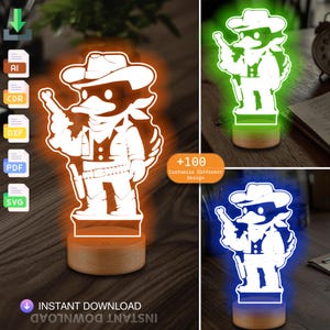 May include: A white cartoon cowboy with a duck bill and a hat is depicted in an orange glow. The image shows a 3D printed night light with a wooden base. The image also shows the night light in green and blue glows. The text "+100 Customize Different Design" is visible in the image.
