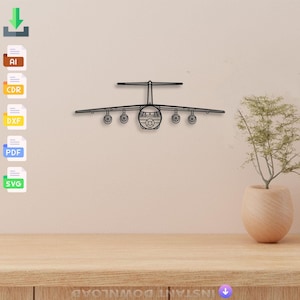 May include: A black metal airplane wall art piece. The airplane has a detailed design with visible wings, engines, and a cockpit. The art piece is mounted on a light-colored wall above a wooden surface. The image also includes file download icons.