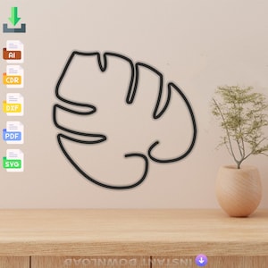 May include: A black line drawing of a monstera leaf on a beige wall. The leaf is a simple outline with no shading or detail. The leaf is centered on the wall and is the only object in the image.