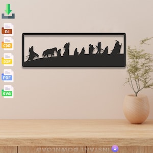 May include: Black metal wall art depicting a silhouette of characters from the Lord of the Rings walking in a line. The art is framed with a black border.