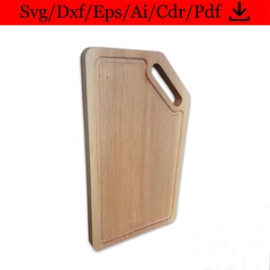 May include: A wooden cutting board with a handle on the side. The board is light brown in color and has a rectangular shape.