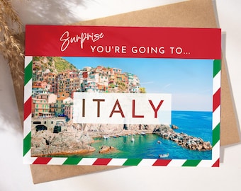 May include: A red and white striped card with a green border. The card says "Surprise you're going to... ITALY" and features a photo of colorful buildings on a cliff overlooking the ocean.