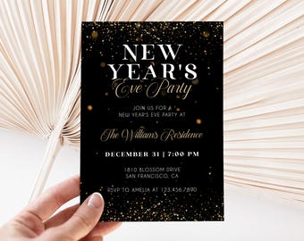 May include: A black New Year's Eve party invitation with gold text and accents. The invitation includes the text "NEW YEAR'S Eve Party" and event details. The invitation is held by a hand, with a neutral background.
