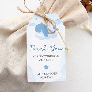 May include: Blue and white thank you tag with a whale wearing a crown on a cloud. The tag says "Thank You for showering us with love!" and "Emily's Shower 10.18.20XX".