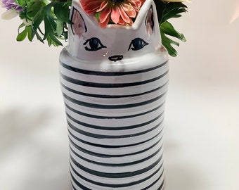 cat hiding vase