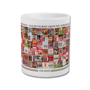 May include: White ceramic mug with a collage of images and text related to Wrexham FC. The mug features the text "WREXHAM FC - RACECOURSE GROUND, WREXHAM" and "THE REDS" with red and green stripes.