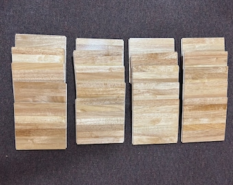May include: Four stacks of light brown wood laminate flooring planks.