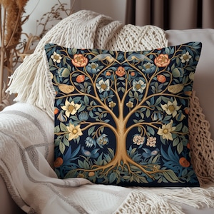 May include: A decorative throw pillow with a dark blue background featuring a stylized tree of life design with intricate details in gold, green, and orange. The tree is surrounded by flowers and birds.