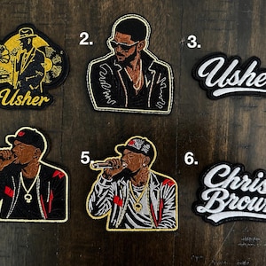 May include: Six embroidered patches featuring musical artists. Patch 1 shows Usher with a gramophone and record. Patch 2 shows Usher in a jacket. Patch 3 says Usher in white script. Patch 4 and 5 show singers with microphones. Patch 6 says Chris Brown.