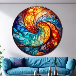 May include: A circular abstract art print with a swirling pattern of blue, yellow, orange, and red colors. The print has a stained glass effect.