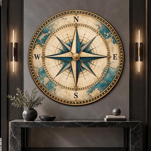 May include: A large circular wall art piece featuring a detailed vintage-style compass rose with blue and cream tones. The design includes cardinal directions N, S, E, and W, surrounded by a decorative gold-toned border with small studs.
