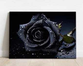 May include: A canvas print featuring a close-up of a black rose covered in water droplets. The dark floral art piece has a stem and a single green leaf. The words "BNM4 DECOR STORE" are printed at the bottom of the canvas.